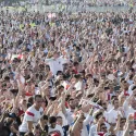 Crowds of fans with England shirts on at a football match