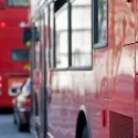 Three red London buses in a queue