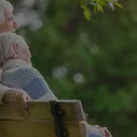 elderly white couple on a bench