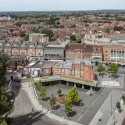 Wide shot of Lyon Road Public Square with Harrow Road town centre and high street in the background