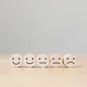 image of smiley faces on round blocks ranging from happy in expression to sad