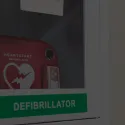 photo of defibrillator behind glass