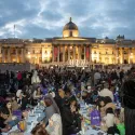 Group of people seating on the ground breaking fast for Ramadan