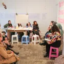 People sitting during an artist panel at an exhibition opening evening 
