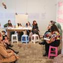 People sitting during an artist panel at an exhibition opening evening 