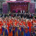 Group of dancers in front of the main stage dancing tradition South Asian dance and in traditional South Asian attire.