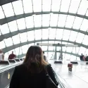 Woman travelling up escalator in Canary Wharf tube station