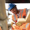 Man on construction site smiling