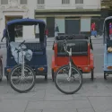 4 pedicabs on street.