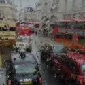 rainy window of car with view of traffic.