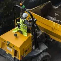 Person sat in yellow digger on construction site