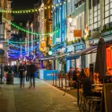 London street in the evening with bars and restaurants