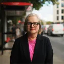 Caroline Russell AM standing in front of a bus stop