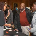 Two men asking for information at event