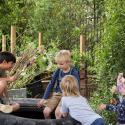 Children on a tire in a garden