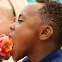 School boy eating apple