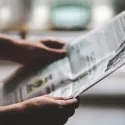 Person holding a newspaper
