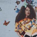 Street art of girl reading book 