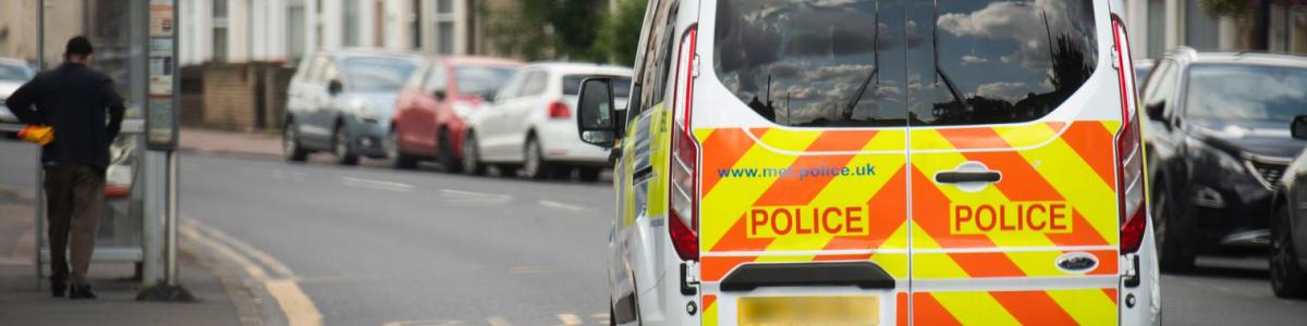 Police van driving through a London street
