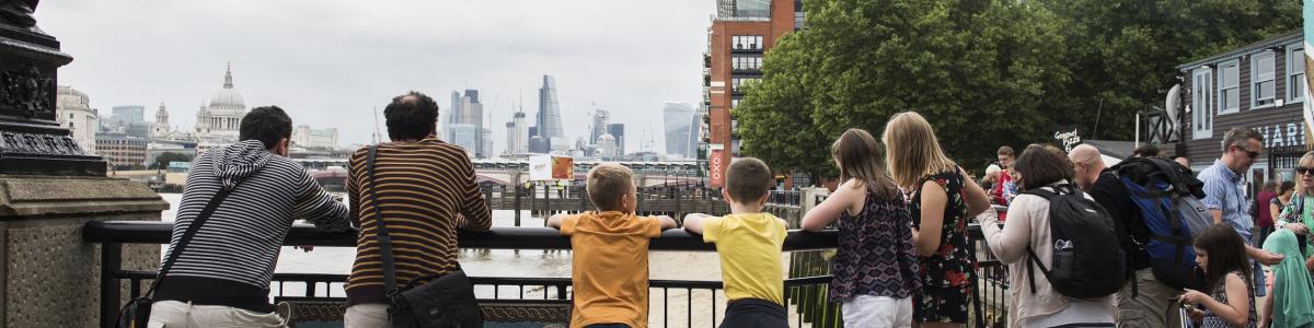 People with suitcases overlooking Gabriel's Wharf