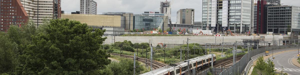 View of a train going past Westfield and John Lewis