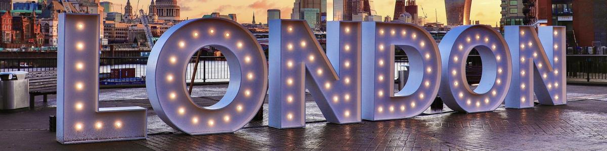 London spelled in lights along the river Thames