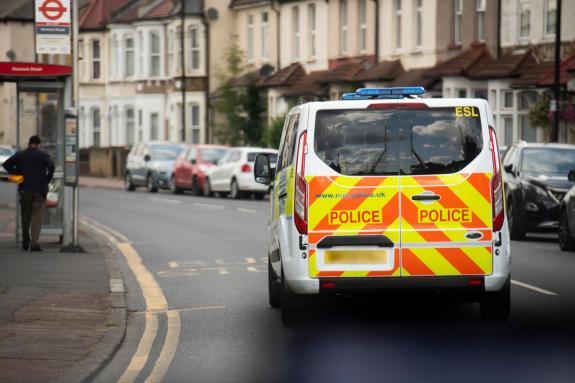 Police van driving through a London street