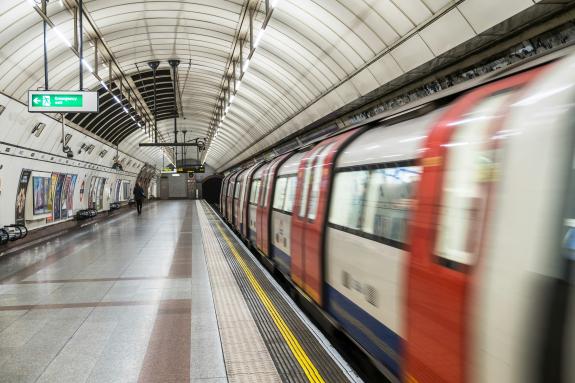 A moving Tube pulling into a station