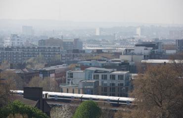 View of London incluidng a trainline and lots of buildings