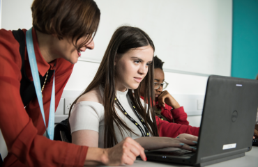 Woman and young girls working on a laptop