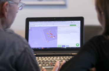 People looking at a laptop