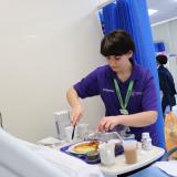 Volunteer helping patient with food