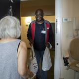 A volunteer assists a service user with shopping.